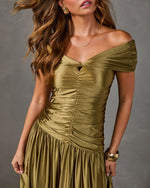 Olive green satin off-the-shoulder drop-waist midi dress with ruched bodice and twist detail, styled with gold jewelry