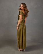 Olive green metallic satin maxi dress with ruched bodice, off-shoulder neckline and drop waist, styled with gold cuff and heels