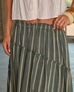 Sage green striped tiered maxi skirt with elastic waist, styled with white crop top and gold jewelry