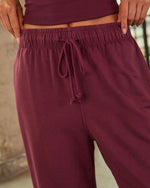 Burgundy drawstring sweatpants with elastic waistband, paired with matching cropped ribbed top, women's loungewear set