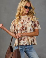 Floral print flutter sleeve babydoll blouse in cream brown botanical pattern, styled with blue jeans and brown suede tote bag