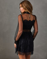 Black lace mini dress with sheer balloon sleeves, high neck, and scalloped eyelash lace hem, shown from the back