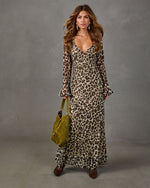 Leopard print chiffon maxi dress with bell sleeves and V-neck, styled with an olive green suede bag and brown boots