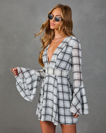 Gray plaid mini dress with deep V-neck, bell sleeves, and flared skirt, styled with retro sunglasses and layered necklaces