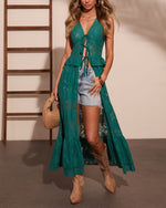 Teal lace halter maxi duster over denim cutoff shorts with tan cowboy boots and woven bag, boho festival style