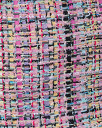 Multicolor fantasy tweed fabric with pink, black, lavender, and yellow woven threads and looped boucle texture