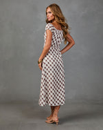 Woman wearing white and plum gingham midi dress with cap sleeves, cinched waist, paired with nude lace-up kitten heels