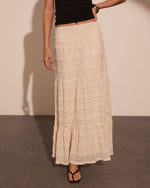 Cream lace tiered maxi skirt with smocked waist, styled with black crop top and black sandals