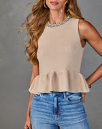 Beige knit peplum sleeveless top with rhinestone neckline, paired with blue high-waist jeans, women's fashion