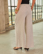Wide-leg striped linen palazzo pants in cream with black pinstripes, elastic waist, worn with black kitten heel sandals