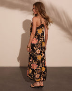 Black floral maxi dress with pink and gold blooms, lace back detail, spaghetti straps, worn with kitten heel sandals