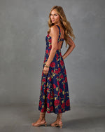 Navy floral midi dress with red rose print, open back, worn with nude strappy heels, back view