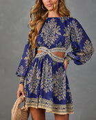 Navy blue and gold floral print boho mini dress with balloon sleeves, cutout waist, and crisscross belt detail