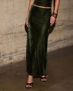 Olive green velvet maxi skirt with low waist and side slit, styled with black strappy heels and gold bangle bracelets