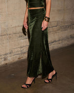 Olive green velvet maxi skirt with front slit, matching crop top, gold chunky bangles and black strappy heeled sandals