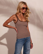 Brown and white striped ribbed tank top on blonde model with aviator sunglasses, layered necklaces, and blue jeans