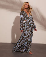Olive green floral maxi dress with blue print, deep V-neck, long sleeves, waist cutout, worn by blonde model