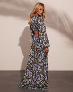 Floral maxi dress with open back cutout, long sleeves, olive and blue print, worn by blonde model