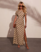 Woman wearing beige brown plaid midi dress with side slit, short sleeves, strappy heels, sunglasses, and tan clutch bag