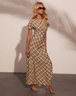 Woman wearing brown plaid maxi dress with short sleeves, ruched waist, paired with nude strappy heels and brown sunglasses