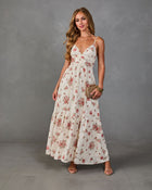 Cream floral maxi dress with pink roses, V-neck, spaghetti straps, tiered skirt, styled with nude heels and woven clutch