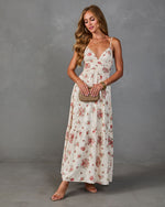 Cream floral maxi dress with pink roses, V-neck, spaghetti straps, tiered skirt, styled with nude heels and woven clutch