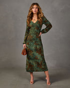 Green floral midi dress with long sleeves and V-neckline, styled with clear heels and a brown leather clutch