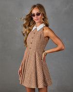 Women's tan tweed sleeveless mini dress with white collar, gold buttons, and fit-and-flare silhouette styled with cat-eye sunglasses