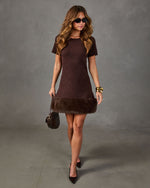 Brown knit mini dress with faux fur hem, short sleeves, black pumps, gold bangles, sunglasses and a quilted crossbody bag