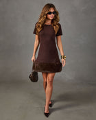 Brown knit mini dress with faux fur hem, short sleeves, black pumps, gold bangles, sunglasses and a quilted crossbody bag