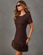 Brown knit mini dress with short sleeves and faux fur hem, styled with gold bangles, hoop earrings and tortoiseshell sunglasses