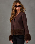 Brown wool-blend jacket with faux fur trim at hem and cuffs, styled with black pants, cat-eye sunglasses and gold jewelry
