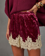Burgundy crushed velvet shorts with cream lace scalloped hem, elastic waist, styled with a wine knit sweater and gold bangles