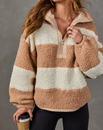 Tan and cream striped sherpa half-zip pullover with oversized fit, styled with black leggings and a to-go coffee cup