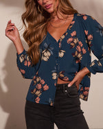 Navy blue floral print button-down blouse with balloon sleeves, worn with dark gray high-waist jeans, women's boho top
