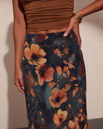 Floral maxi skirt in teal with warm amber poppy print, styled with brown ruched crop top and gold bangle bracelet