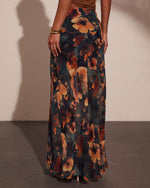 Dark floral maxi skirt with rust and amber blooms on teal background, paired with brown top and gold bangles