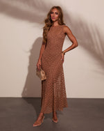 Brown lace maxi dress on model with gold hoop earrings, clutch bag, and nude heels against neutral background