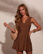 Brown polka dot mini dress with button front and V-neckline, styled with woven beige bag and gold bangles