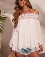 White off-shoulder lace crochet boho blouse with long sleeves and flowy silhouette, paired with denim cutoff shorts