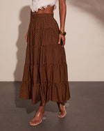 Brown polka dot tiered maxi skirt with smocked waist, styled with white lace crop top and clear heel sandals