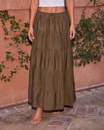 Olive green tiered maxi skirt with drawstring waist, paired with white crop top and tan sandals, boho style