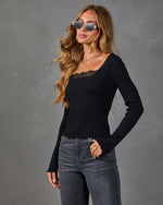 Black ribbed lace-trim long sleeve crop top paired with gray high-waist jeans, modeled with gold sunglasses