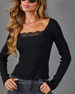 Black ribbed knit long-sleeve top with lace neckline trim, paired with gray jeans and gold layered necklaces
