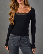 Black ribbed knit long sleeve top with lace neckline trim and lettuce hem, styled with gray jeans