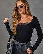 Black ribbed lace-trim long sleeve bodysuit styled with dark jeans, woven leather bag, gold sunglasses, and layered necklaces
