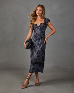 Dark floral satin midi dress with lace trim neckline and hem, cap sleeves, styled with black strappy heels and clutch bag