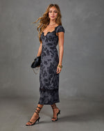 Dark floral satin midi dress with lace trim neckline and hem, puff sleeves, styled with black strappy heels and chain bag