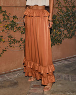 Copper satin maxi skirt with ruffle hem and waist detail, styled with nude strappy heels and cream crop top