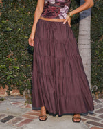 Burgundy tiered maxi skirt with drawstring waist, paired with floral crop top and black strappy sandals